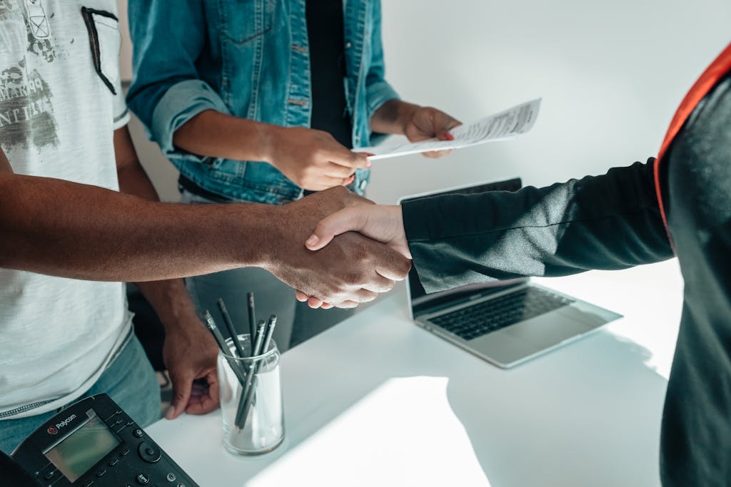 Two business professionals engaging in a handshake after reading the insights library